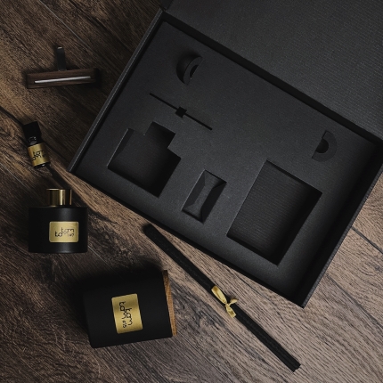 Black KAM KAM home fragrance box with corrugated insert, offering bottle protection.