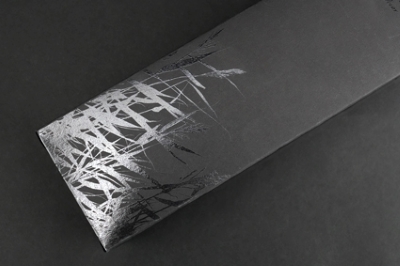 Spot UV coating on black cardboard adds gloss to the logo design.